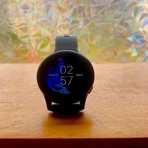 Garmin Venu, smart fitness watch with charger, protective covers, and bands.